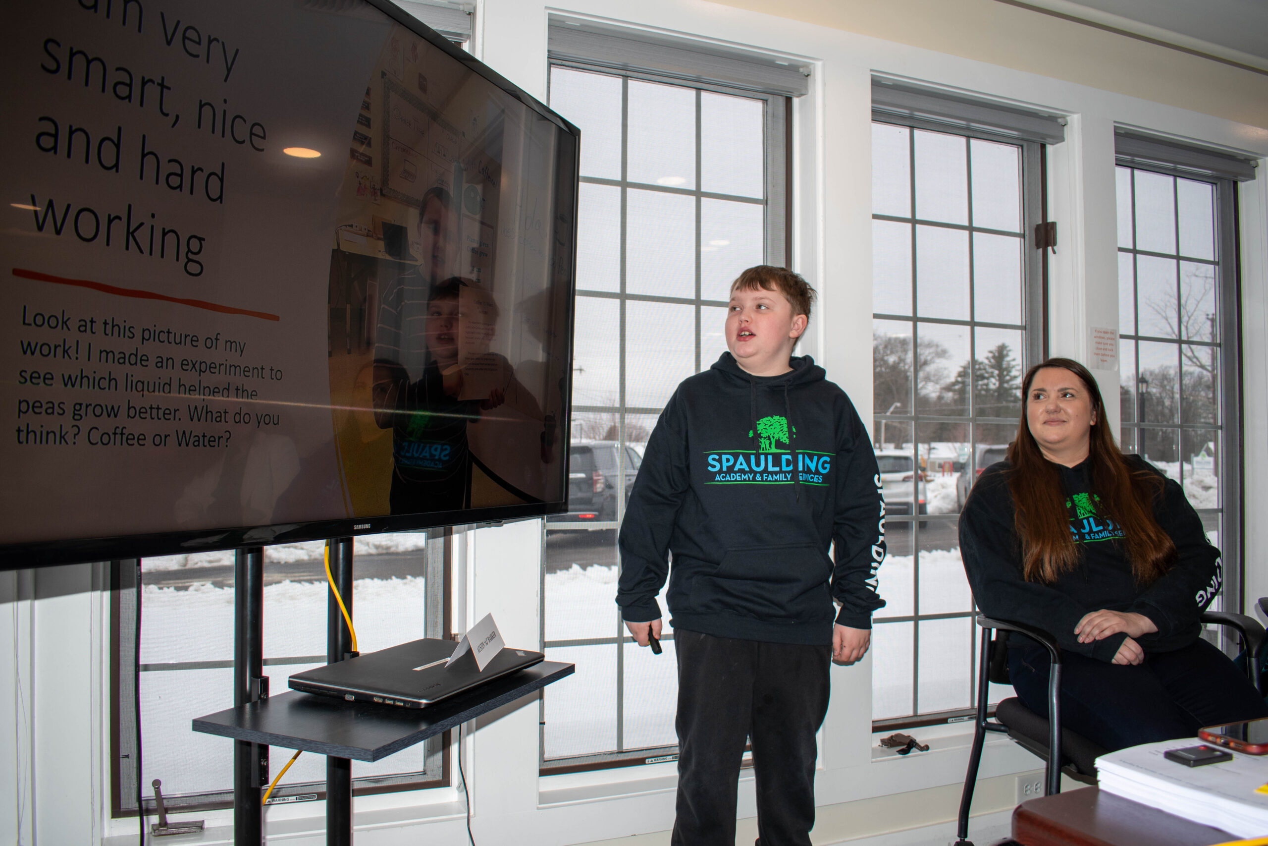 Student presenting academic project in front of class