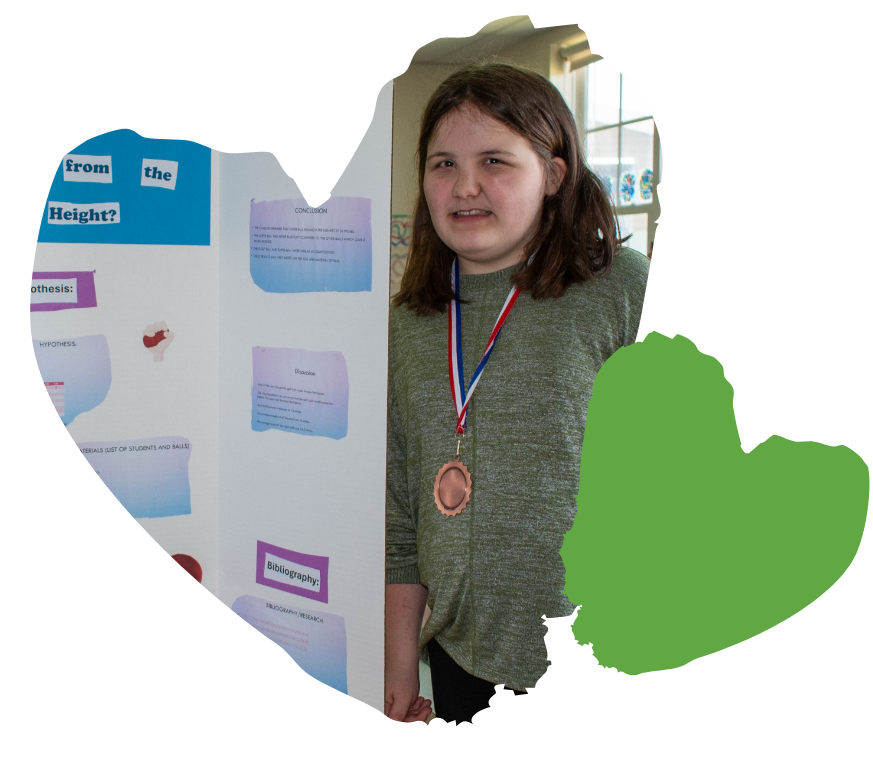 girl poses with her poster board presentation