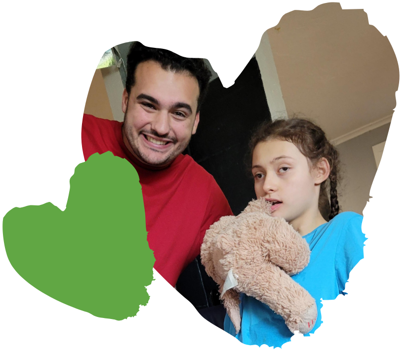 spaulding staff member and student holding teddy bear pose for picture