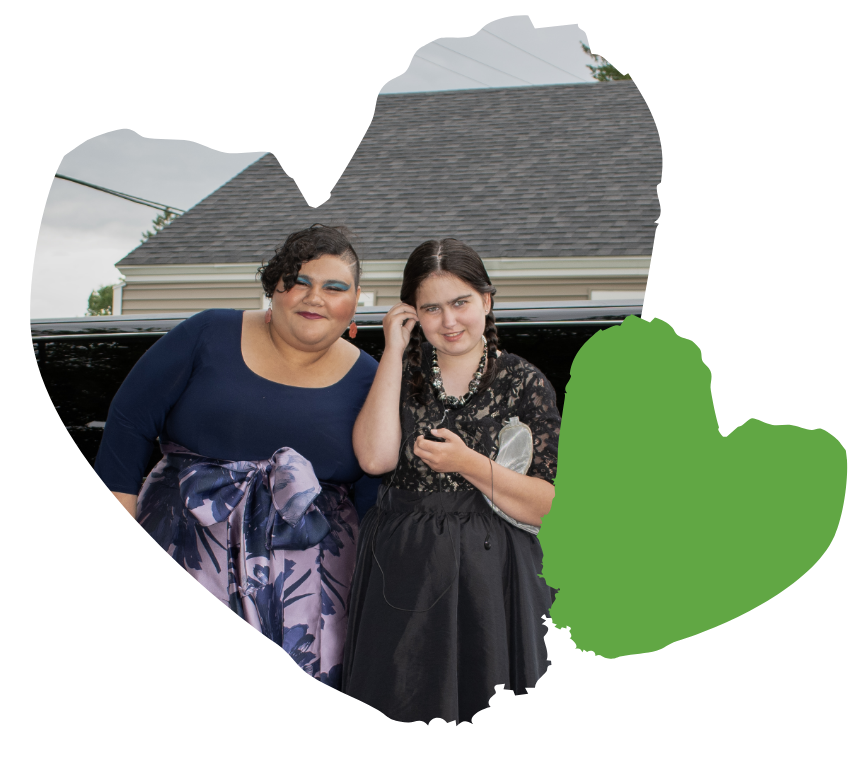 two spaulding students smile infront of limo outside before prom