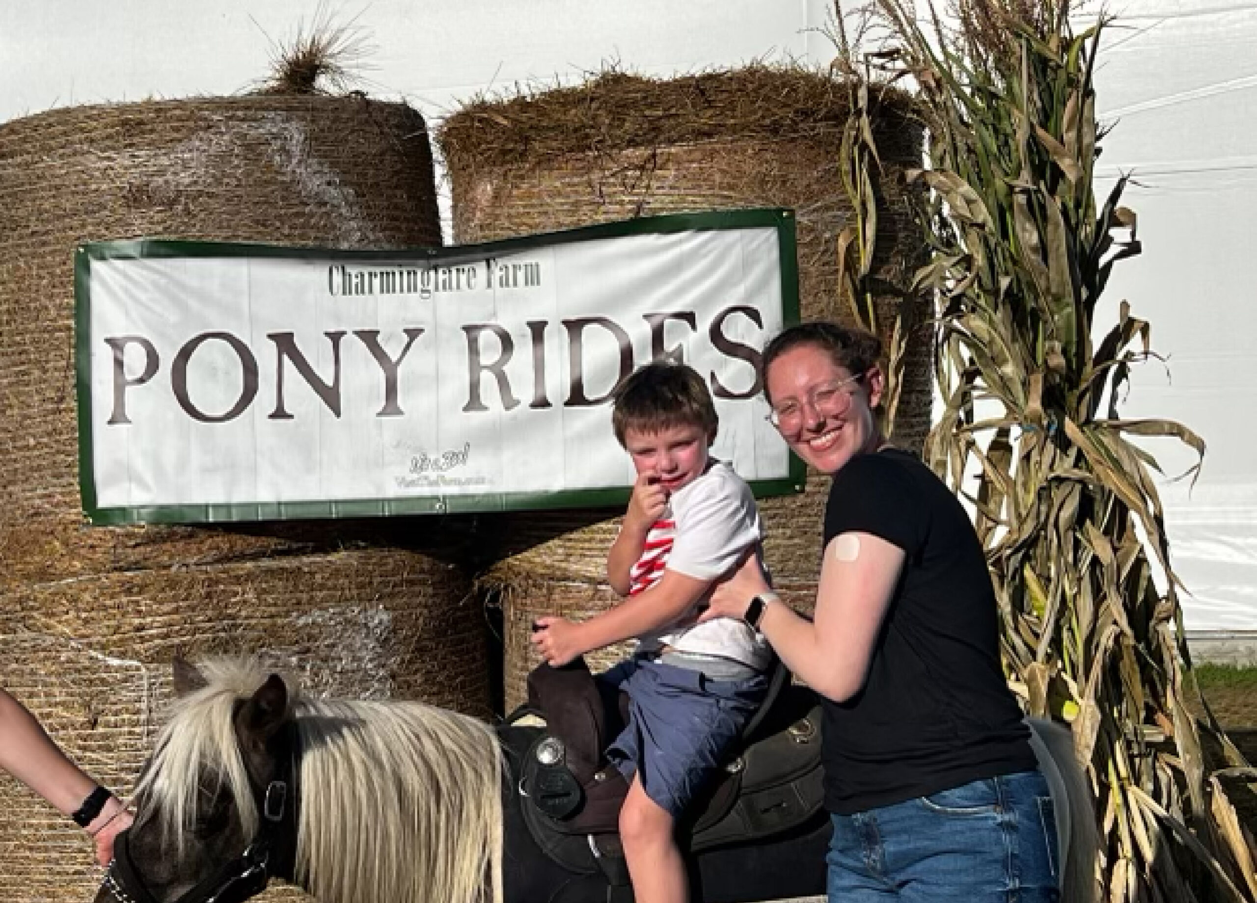 Foster mother and son pose for photo during pony ride