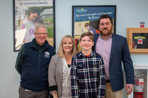 220422-Science-Fair-Todd-Amanda-Garrett-Destiny-A (2) Spaulding student smiling with staff